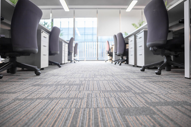 Modern office workspace with carpet tile flooring.
