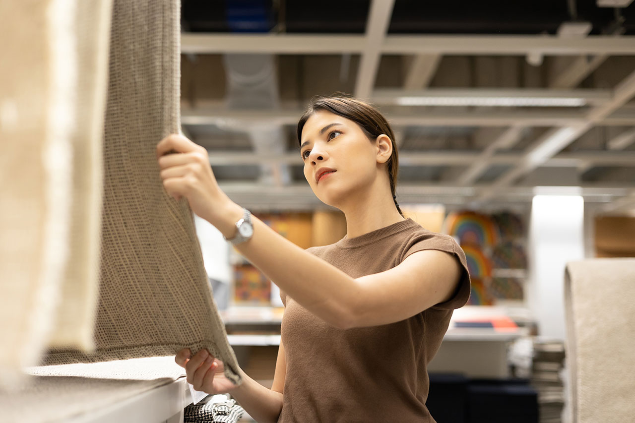Woman checking out carpets at a showroom
