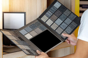 A man choosing between carpet samples